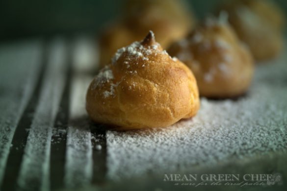 Pate a Choux Pastry dusted with powdered sugar with symmetrical vertical lines.
