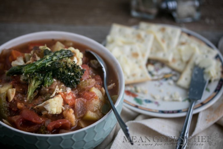 Side photo of a honeycomb pattern blue bowl filled with Hearty Vegetable Soup, Mean Green Chef.