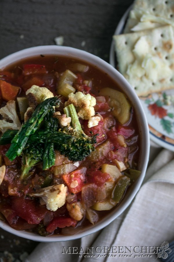 Overhead photo of a honeycomb pattern blue bowl filled with Hearty Vegetable Soup, Mean Green Chef.