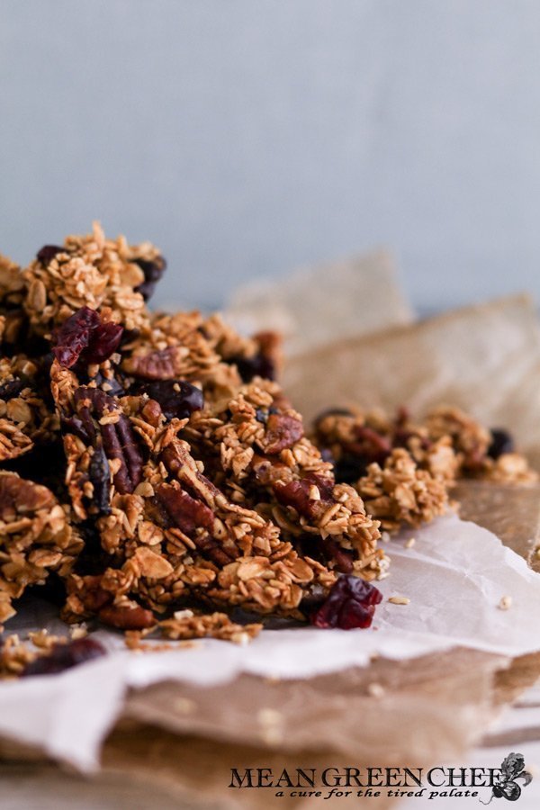 Side photo of a pile of Brown Butter Granola sitting on wrinkled parchment paper.