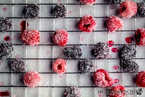 Sugared Blackberries and raspberries drying on a baking rack.