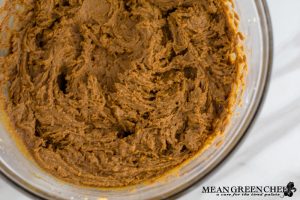 Ingredients for Best Ever Molasses Cookies beaten in a large glass bowl.