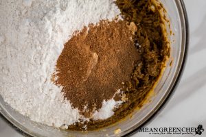 Ingredients for Best Ever Molasses Cookies flour, cinnamon, allspice, ginger, and nutmeg in a large glass bowl.