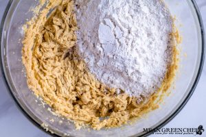 Ingredients for Bakery Style Chocolate Chip Cookies in a large glass bowl.