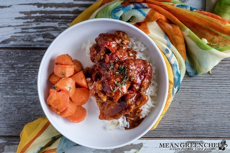 Overhead photo of Chicken Pierre in a white bowl with roasted honey carrots.