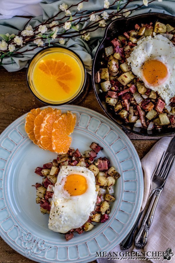 Overhead shot of Restaurant Style Corned Beef Hash topped with sunny side up eggs.