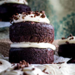 Side photo of Guinness Chocolate Cake with chocolate shavings sitting on parchment paper.