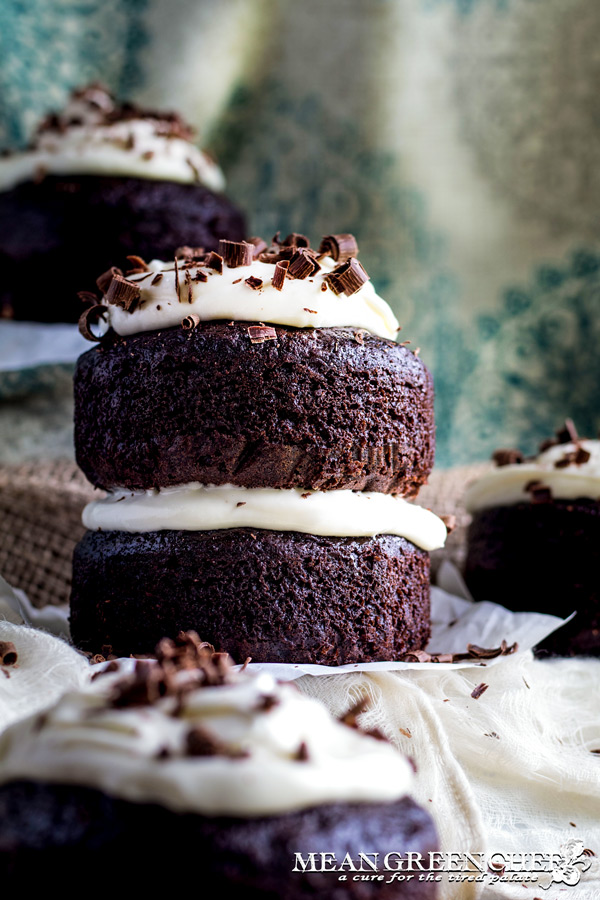 Side photo of Guinness Chocolate Cake with chocolate shavings sitting on parchment paper.