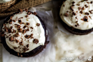 Overhead view of Guinness Chocolate Cake with chocolate shavings sitting on parchment paper.