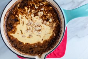 Batter for Chocolate Guinness Cake in a blue pot that has just come off of the burner.