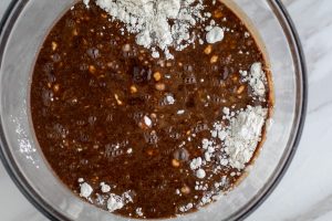 Ingredients for making Chocolate Guinness Cake being blended in a large glass bowl.