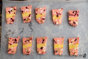 Overhead shot of layered Orange Cranberry Icebox Cookie dough on baking sheet.