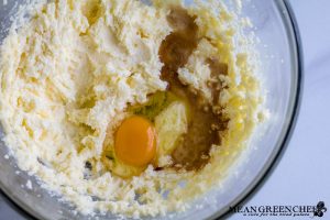 Dough being mixed with egg and vanilla extract for Orange Cranberry Cookies.