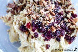 raw cookie dough with pecans, dried cranberries and a dot of pink food coloring for layered Orange Cranberry Icebox Cookies.