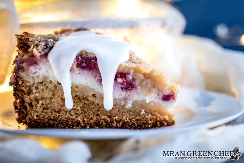 Side photo of Raspberry Coffee Cake with thick dripping vanilla glaze.