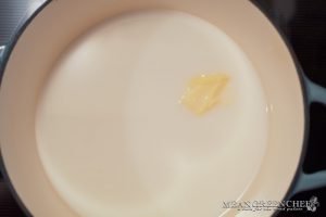 Overhead shot of a bowl of Spiced Mandarin Pecan Oatmeal garnished with whipped cream and Sumo Citrus.