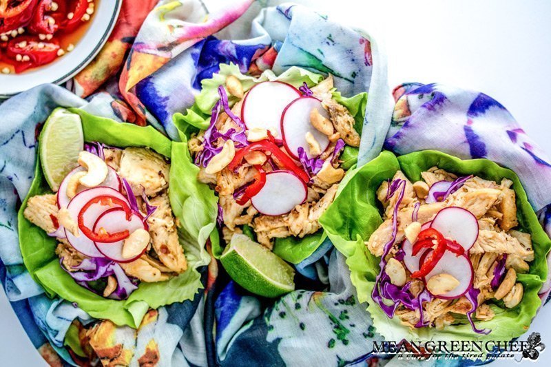 Thai Chicken Lettuce Wraps on a white background with Prik nam pla.