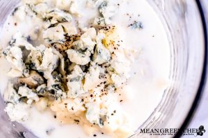 Buttermilk Blue Cheese Dressing being mixed in a large glass jar.