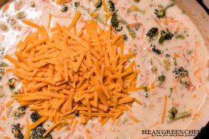 Bistro Broccoli Cheese Soup being made in a large gray Dutch Oven on the stove top.