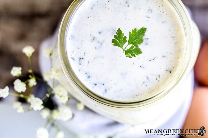 Herbed Buttermilk Ranch Dressing in a large mouthed mason jar garnished with green parsley.