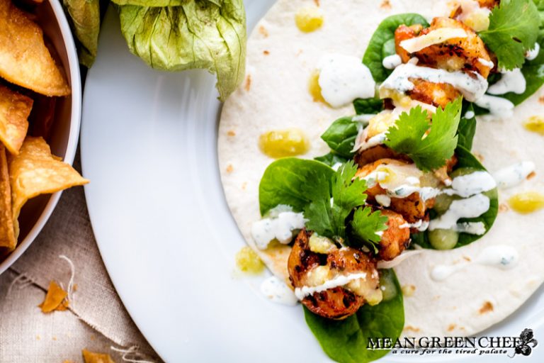 Overhead photo of blackened shrimp taco on a soft tortilla.