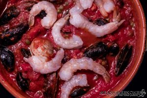 Shrimp being added to Pasta Pescatore.