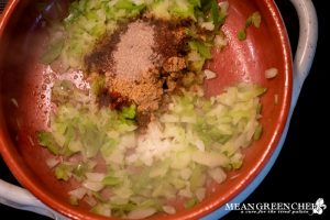 Spices and ingredients cooking for Shakshuka.