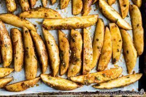 Crispy oven baked fries on a sheet pan ready to be baked.