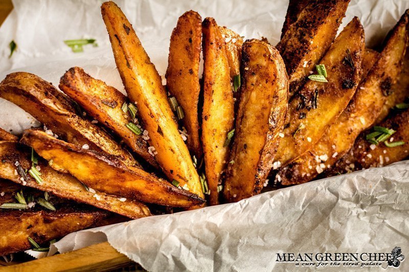 Crispy Oven Baked Fries sprinkled with fresh chopped Rosemary and Kosher sea salt.