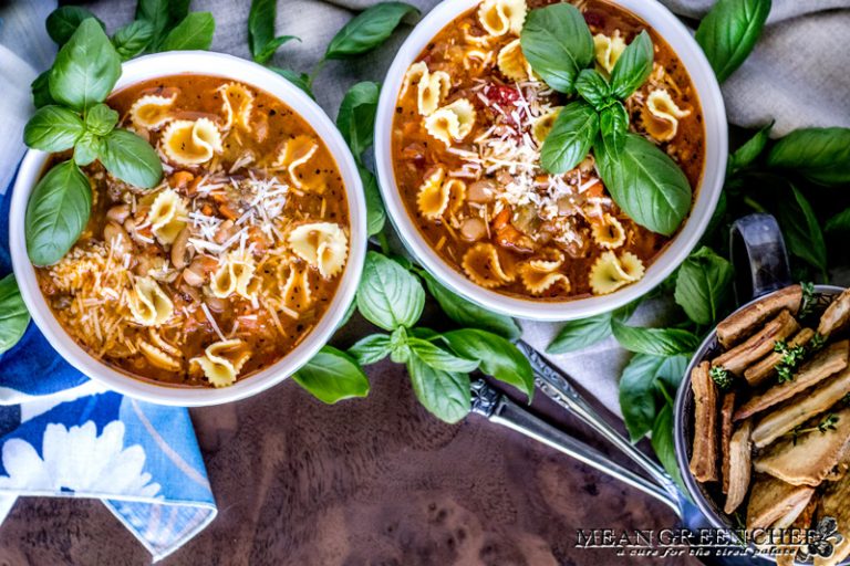 Two bowls of Pasta e Fagioli with crackers.