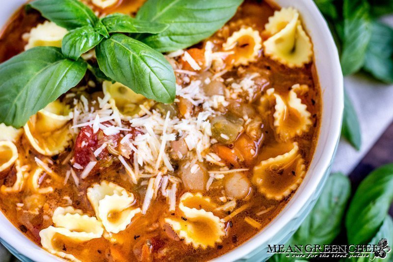 Bowl of Pasta e Fagioli with fresh basil.