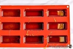Silicone molds with caramel coating the sides.