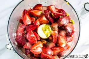 Strawberries, lime zets, lemon zest and sugar in food processor for Strawberry Iced tea.