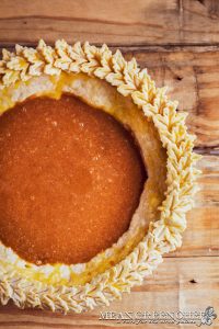 Dark filling poured into pie crust for Punch of Pumpkin Pie