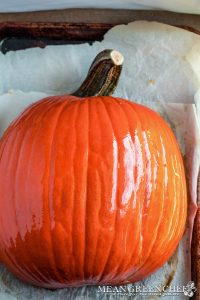 Sugar Pumpkin ready to be roasted on a parchment lined baking sheet.