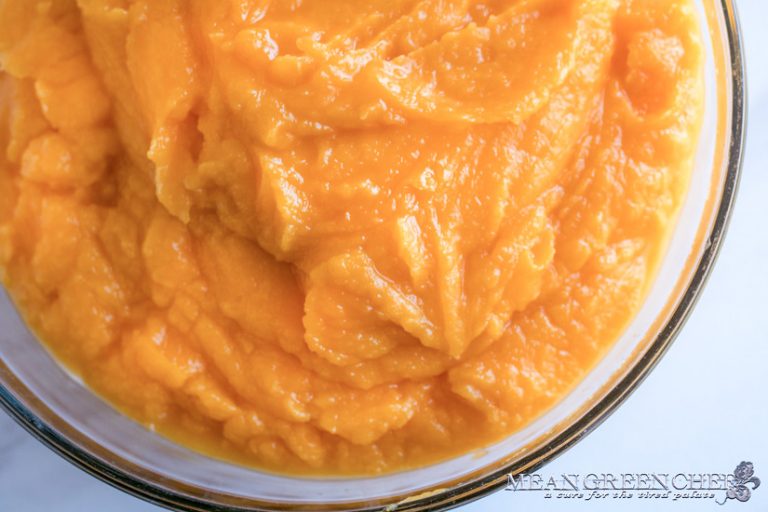 Roasted pumpkin puree in a glass bowl.