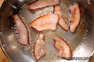 Pork jowl sautéing in a hot sauté pan for making Slow Cooker Texas Pinto Beans.