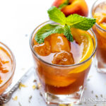 Instant Pot Peach Iced Tea in a cold glass garnished with fresh mint and peaches.