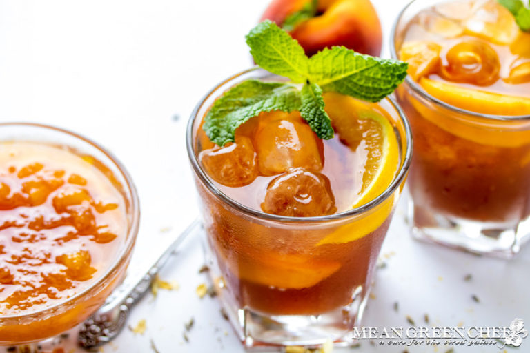 Instant Pot Peach Iced Tea in a cold glass garnished with fresh mint and peaches.