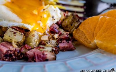 Overhead shot of Restaurant Style Corned Beef Hash topped with sunny side up eggs.